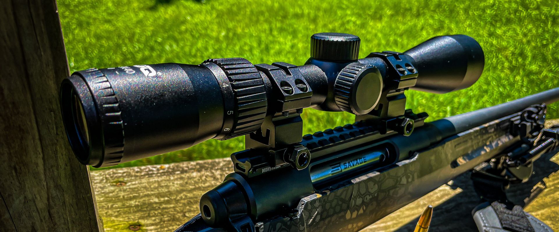 Close-up of UUQ VibeShield Series Rifle Scope mounted on a sniper rifle, suitable for deer hunting and precision shooting.